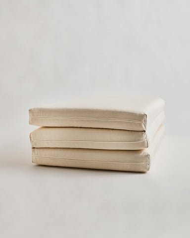 tri-fold futon floor pad by Iwata on a light gray background