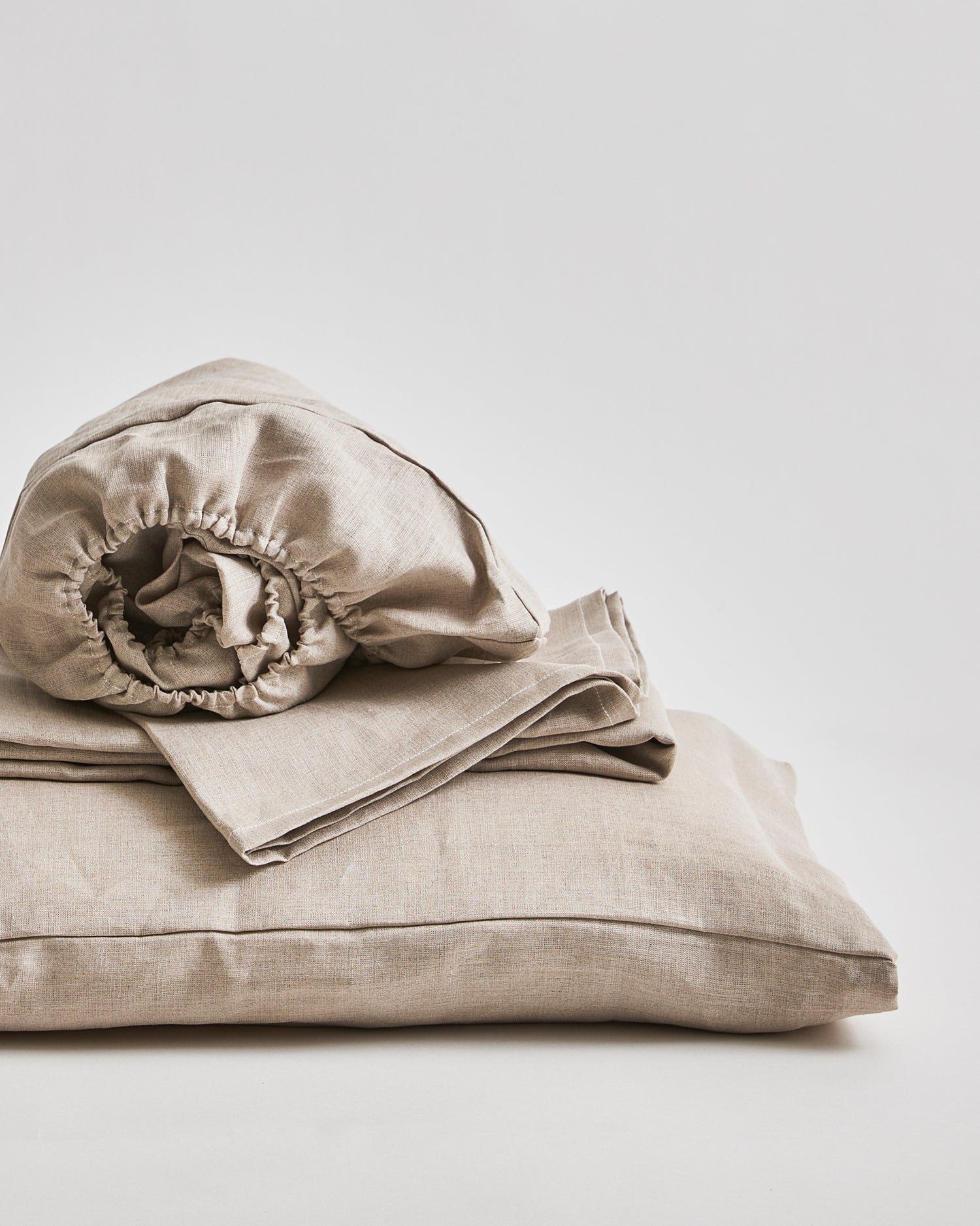 Up-close of Unbleached Linen Sheet Set by Iwata on a gray background