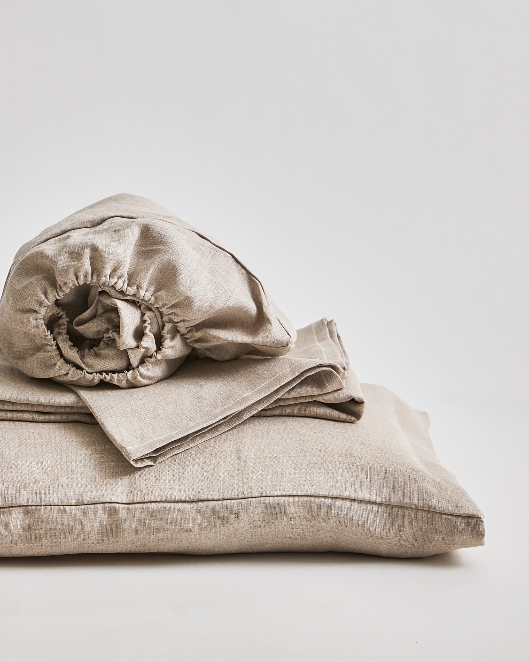 Up-close of Unbleached Linen Sheet Set by Iwata on a gray background