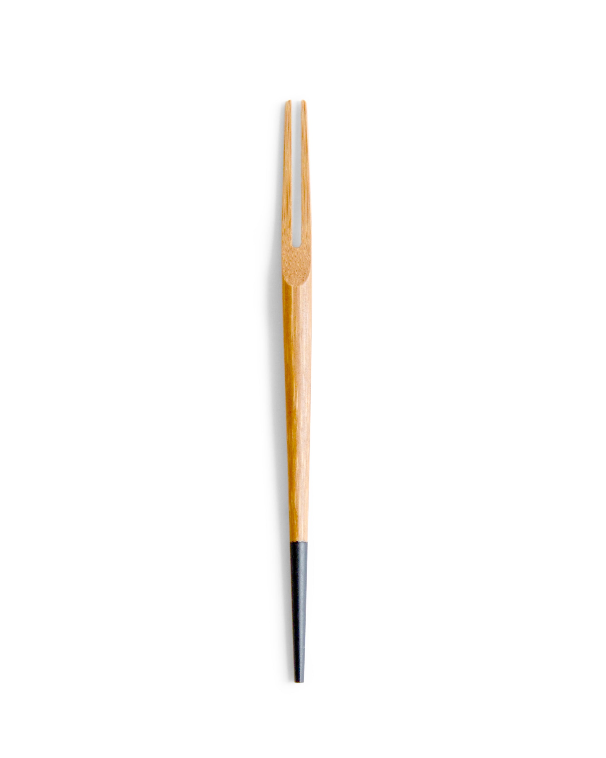 One small two pronged bamboo fork by Kohchosai Kosuga with black end against a white background