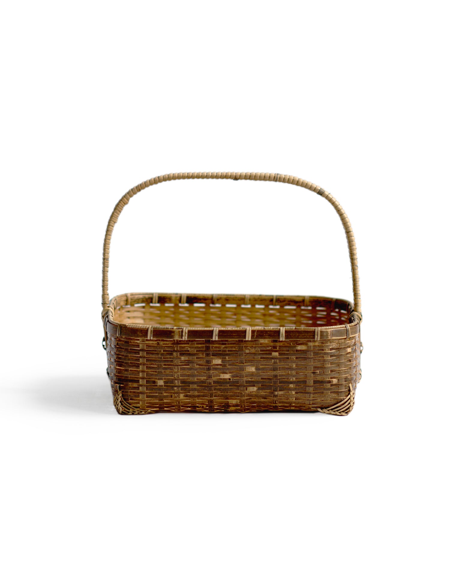Silhouetted front image of square toradake bread basket with handle by Kohchosai Kosuga against white background.