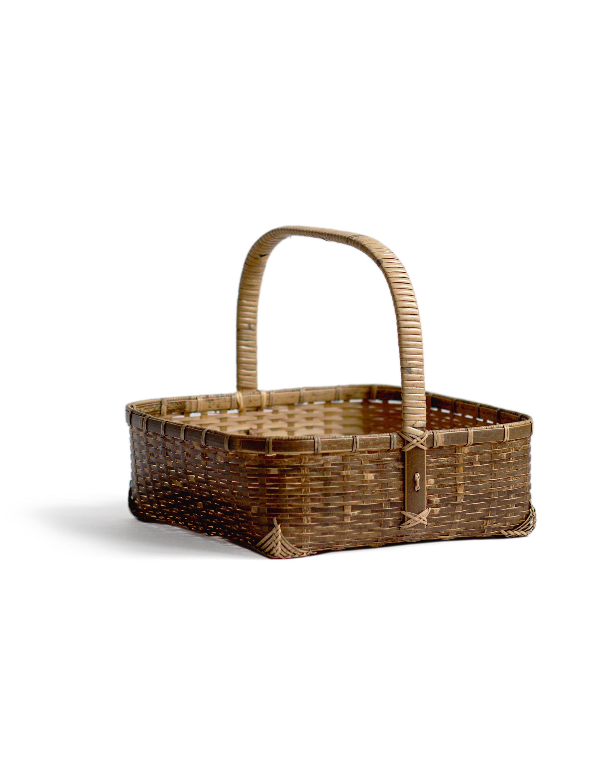 Silhouetted angled image of square toradake bread basket with handle by Kohchosai Kosuga against white background.