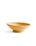 Bamboo woven bowl sitting against white background.