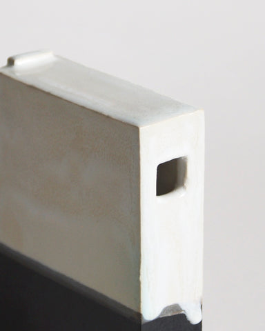 Up-close of Black and White Hanging Vase by Masanobu Ando on a gray background