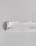 Up-close of white ceramic boundary sculpture by Masanobu Ando on a gray background