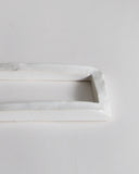 Up-close of white ceramic boundary sculpture by Masanobu Ando on a gray background