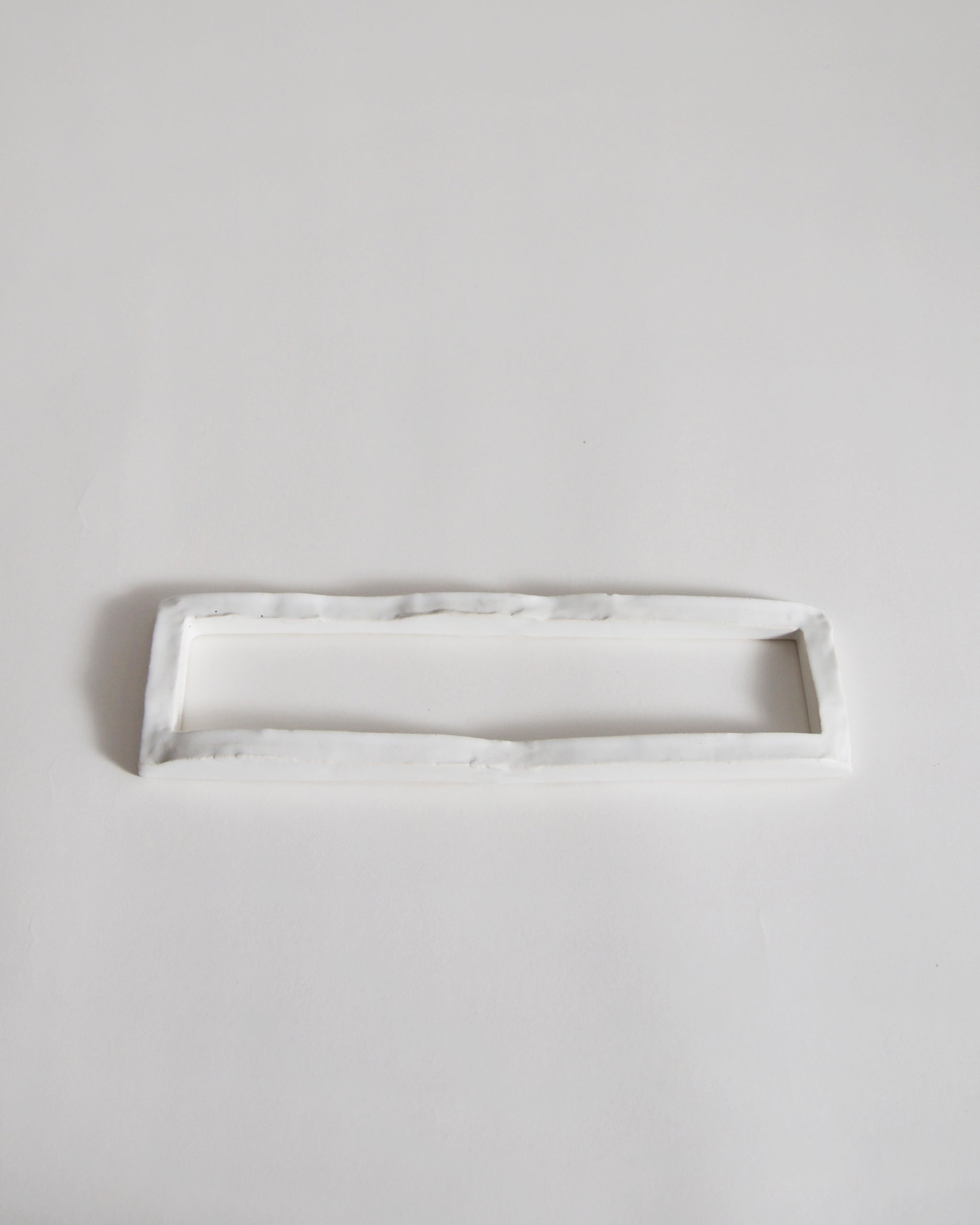 white ceramic boundary sculpture by Masanobu Ando on a gray background