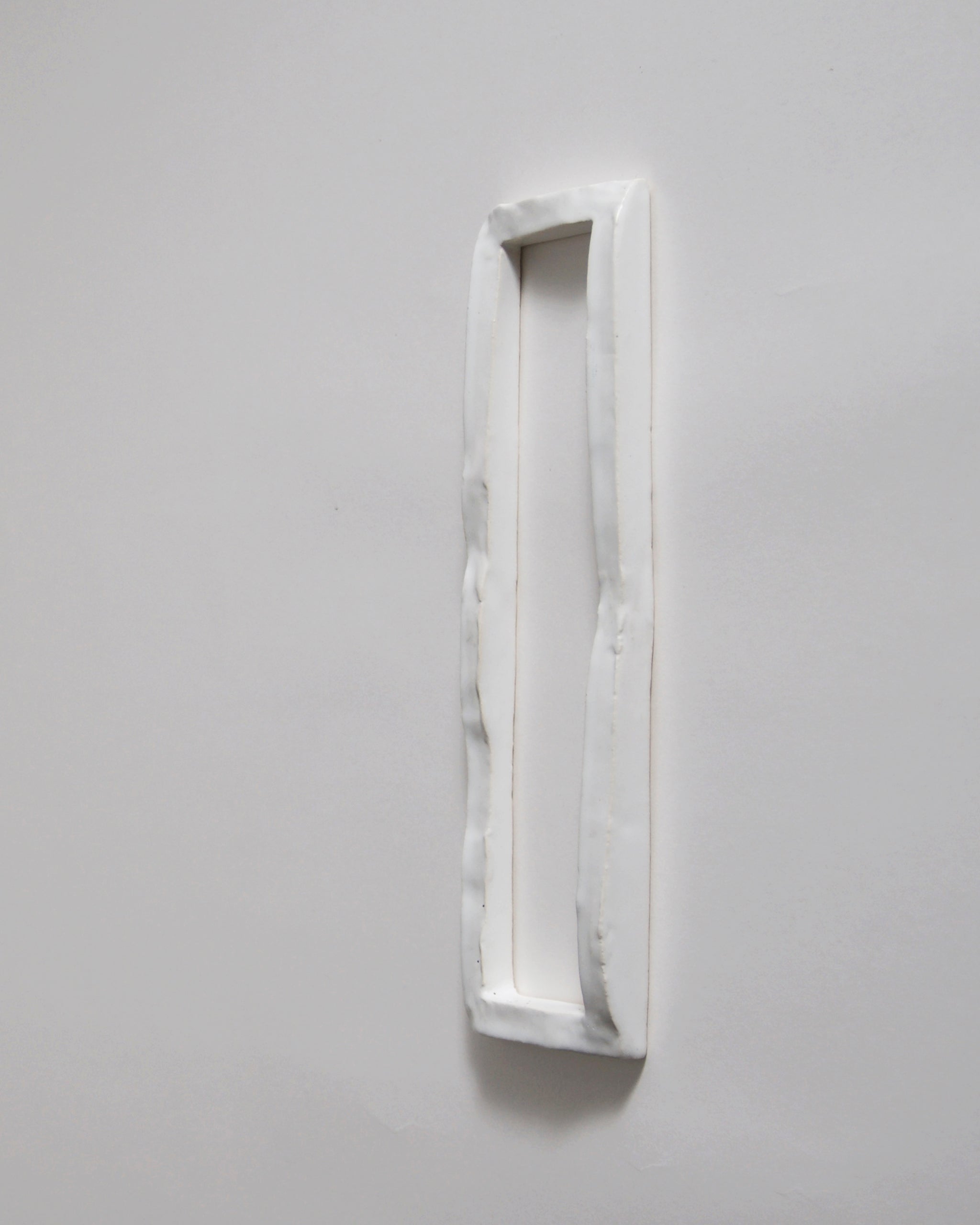 White ceramic boundary sculpture by Masanobu Ando on a gray 