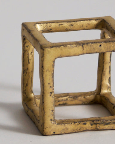 Up-close of Gold Box of Air by Masanobu Ando on a gray background