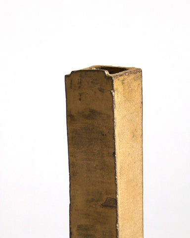 Up-close of the top of Gold Hanging Vase by Masanobu Ando on a gray background