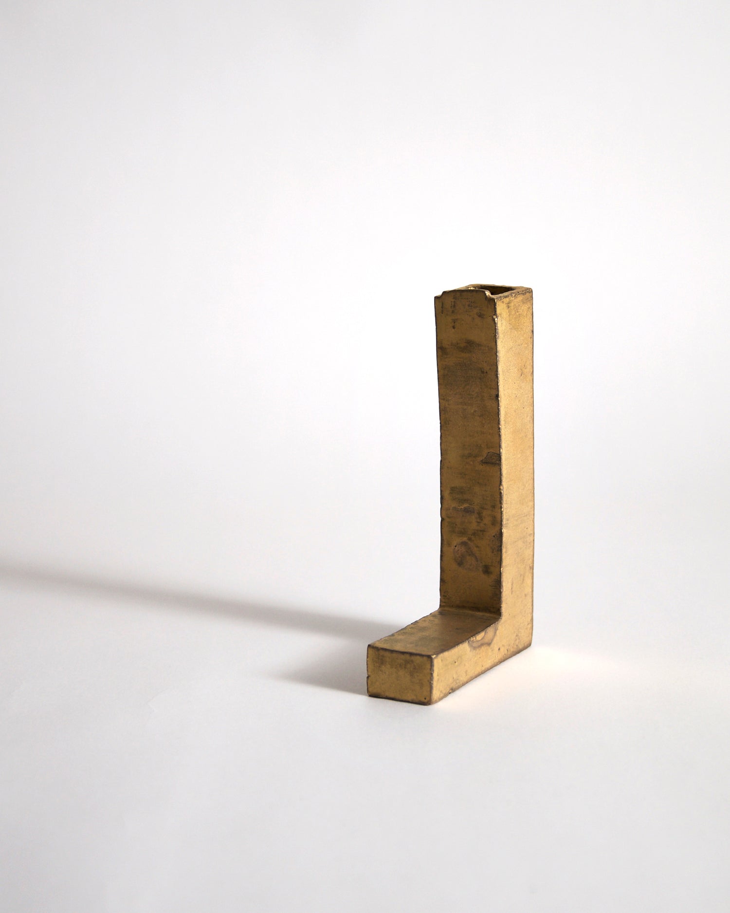Gold Hanging Vase by Masanobu Ando on a gray background
