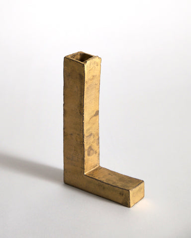 Gold Hanging Vase by Masanobu Ando on a gray background