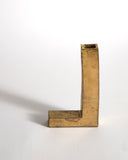 Gold Hanging Vase by Masanobu Ando on a gray background