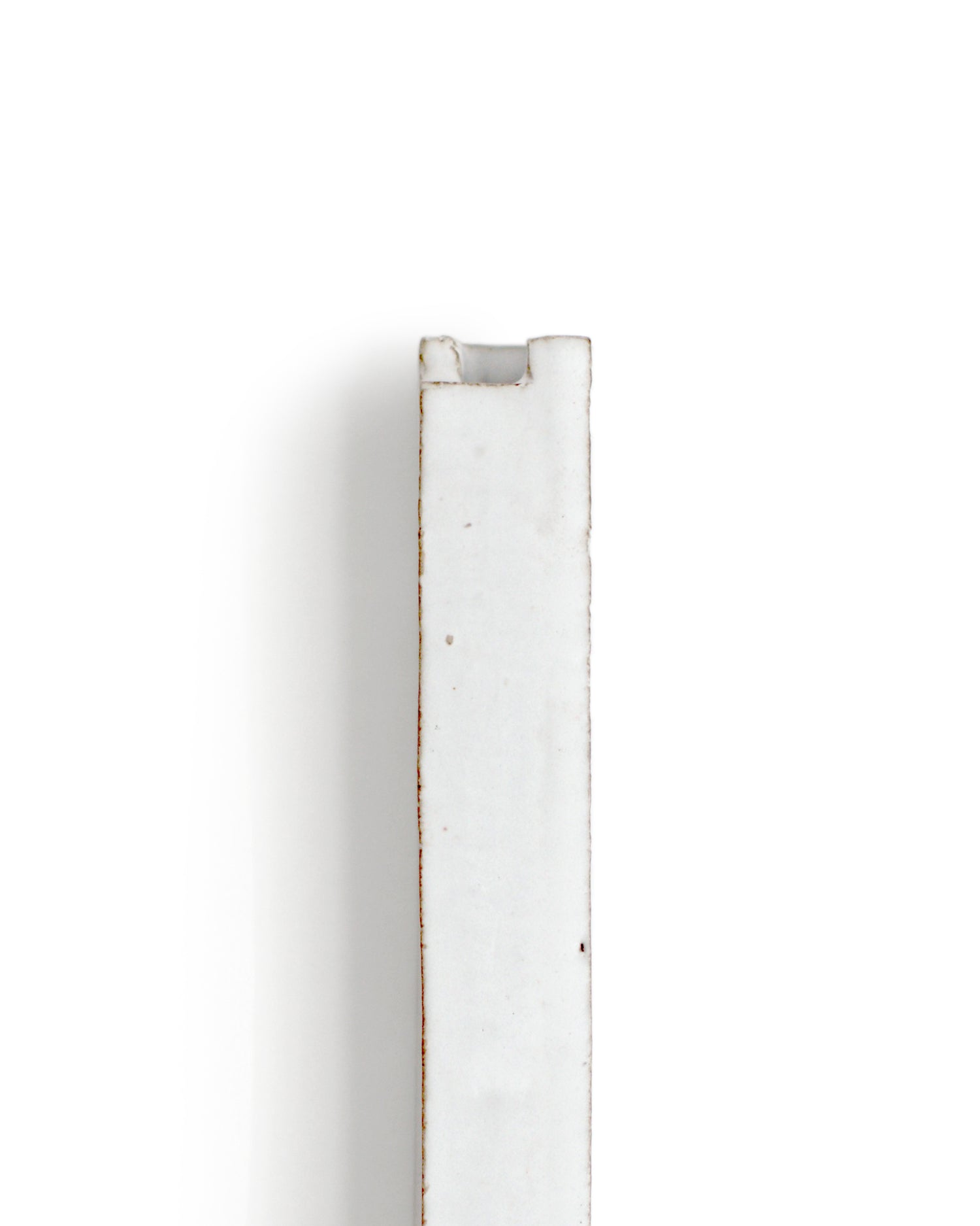 Zoomed-in image of top of short white hanging sculpture vase with white overglaze by Masanobu Ando against white background.