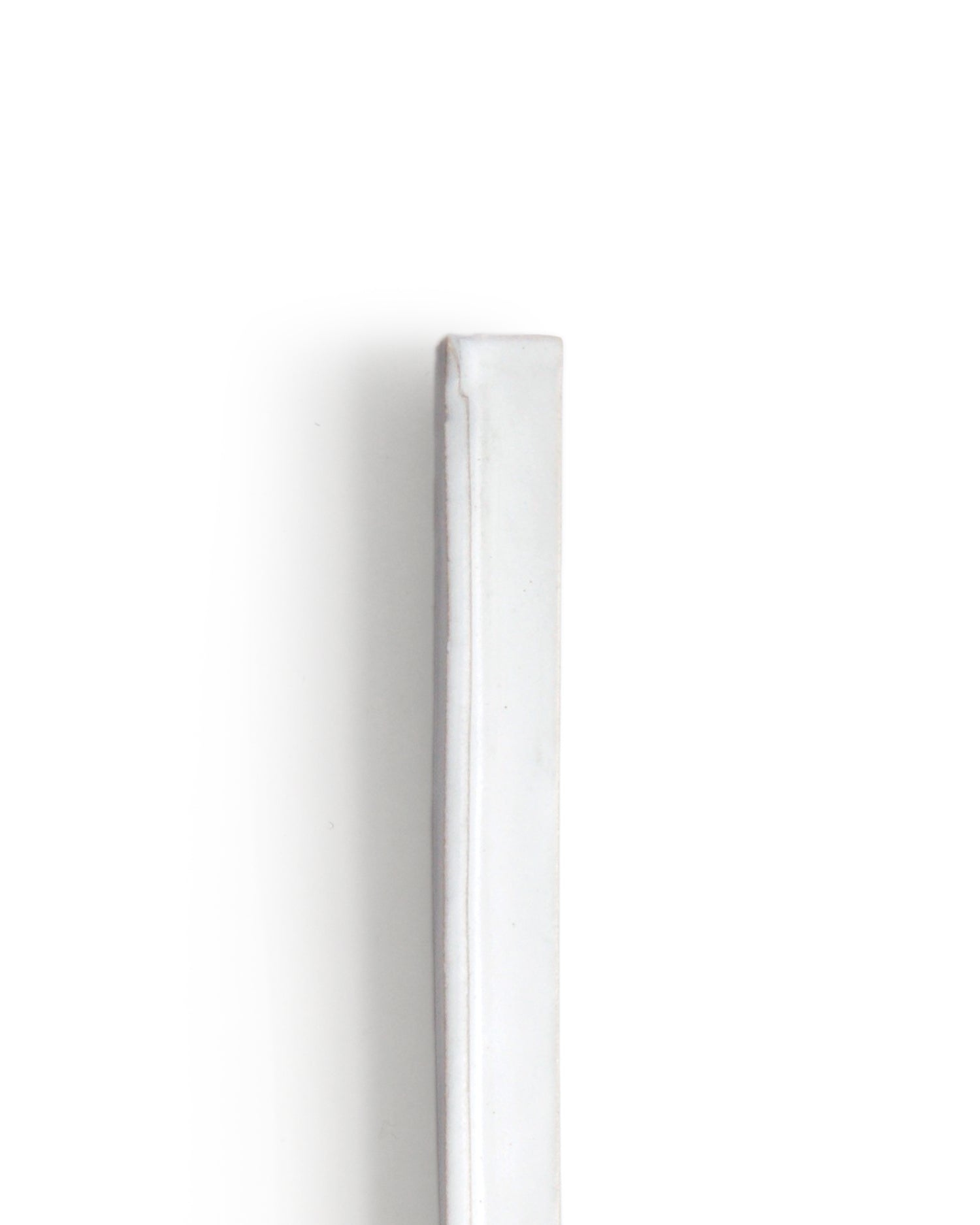 Zoomed-in image of top of ceramic slim white hanging vase with edge with white over glaze by Masanobu Ando against white background.