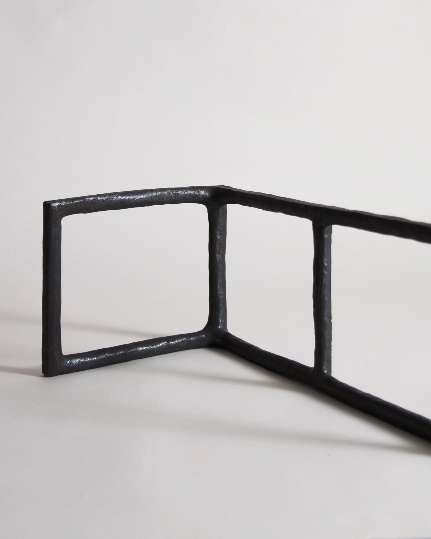 Up-close of Black Rust Glaze Boundary Sculpture by Masanobu Ando on a gray background