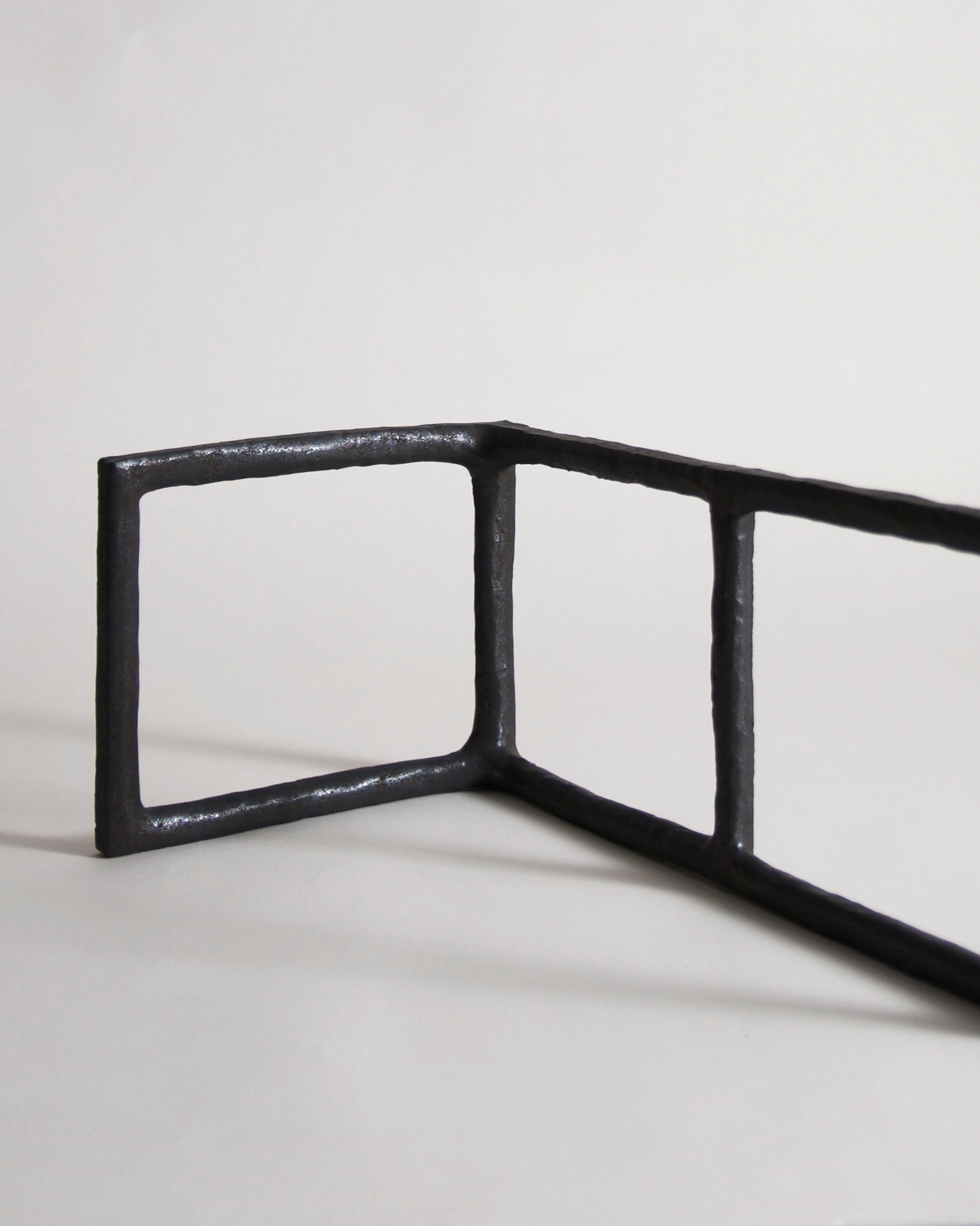 Up-close of Black Rust Glaze Boundary Sculpture by Masanobu Ando on a gray background