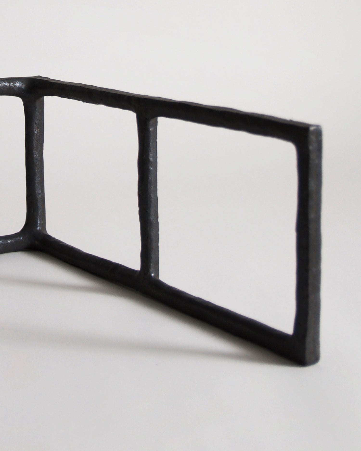 Up-close of Black Rust Glaze Boundary Sculpture by Masanobu Ando on a gray background