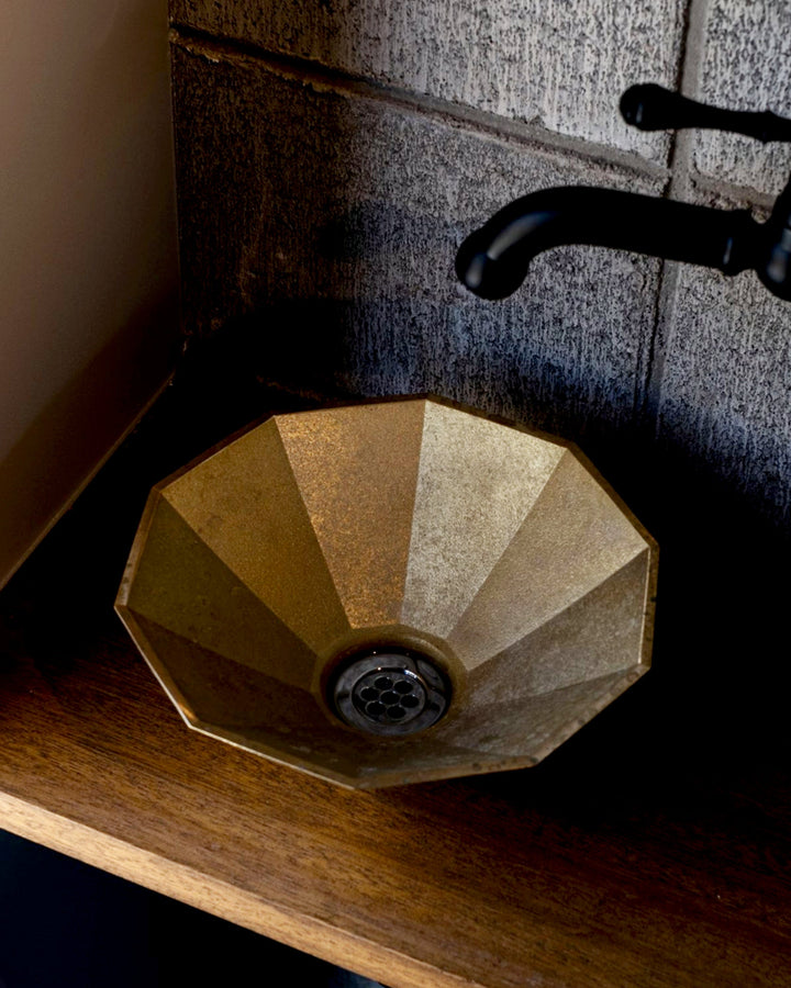View from the top of matureware wash bowl is installed on a wooden countertop, connected to a black faucet.