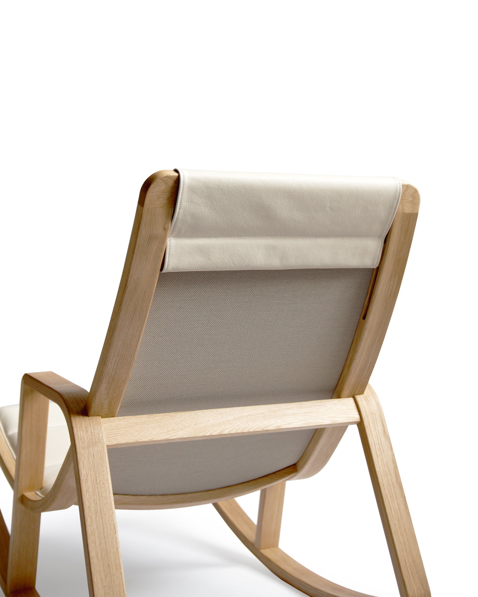 Cropped detail image showing the back of tonton rocking chair. Adjustable neck pillow is shown.