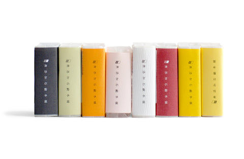 Eight bars of soap by Mutenka Sekken lined up next to each other colourful spines facing out.