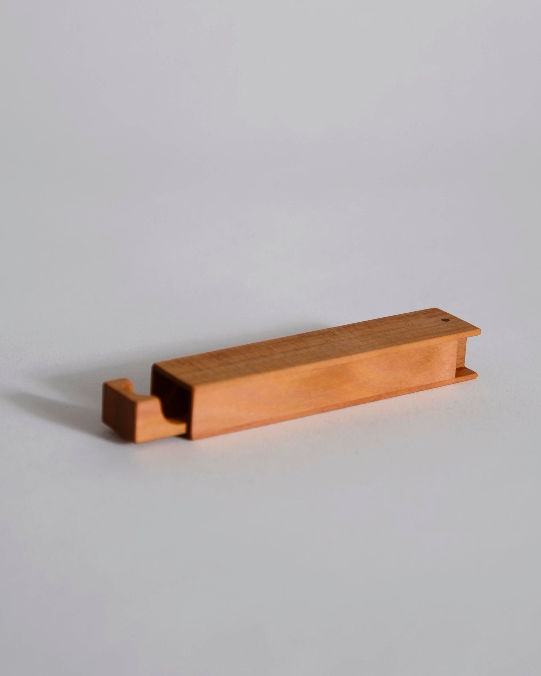 Cherry wood toothpick case by Nalata Nalata and Tanno on a gray background