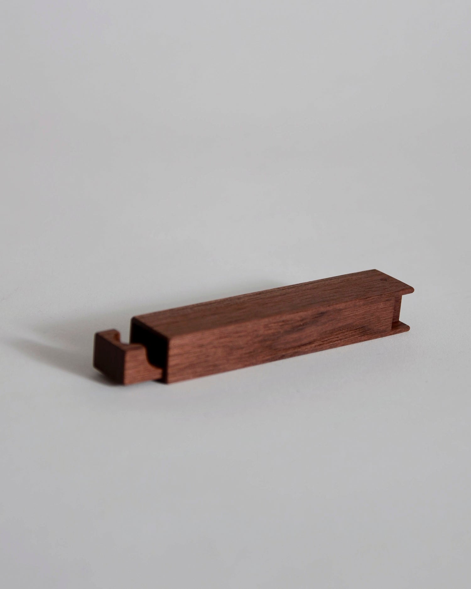 Walnut wood toothpick case by Nalata Nalata and Tanno on a gray background