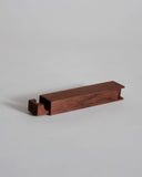 Walnut wood toothpick case by Nalata Nalata and Tanno on a gray background