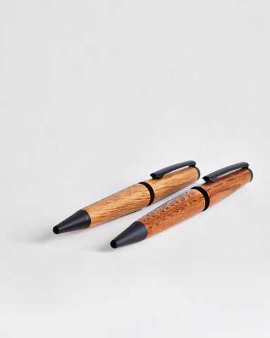 Two wooden pens by Nalata Nalata on a gray background
