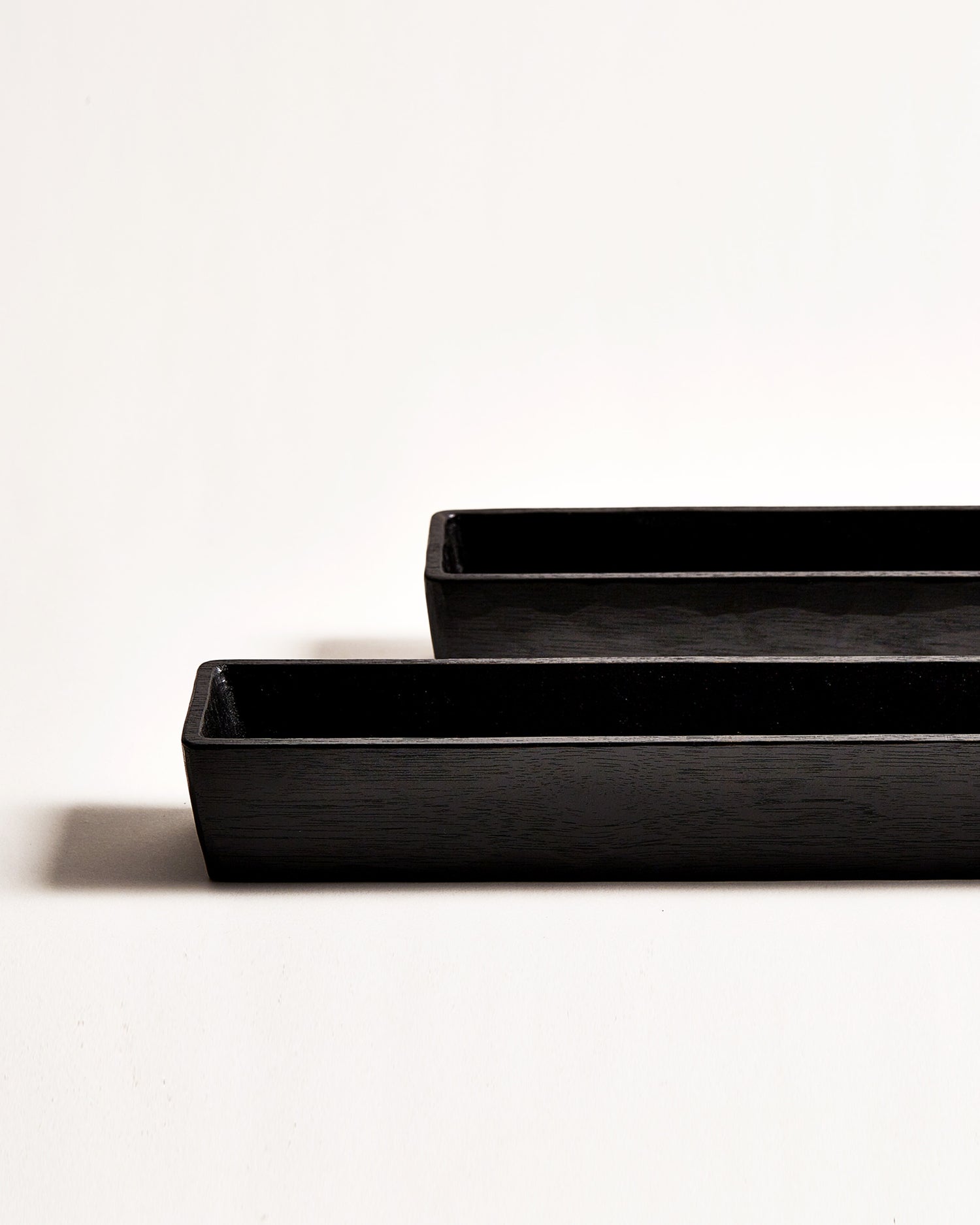 Cropped view of 2 staggered Chopsticks Holders by Ryuji Mitani against white-gray background.