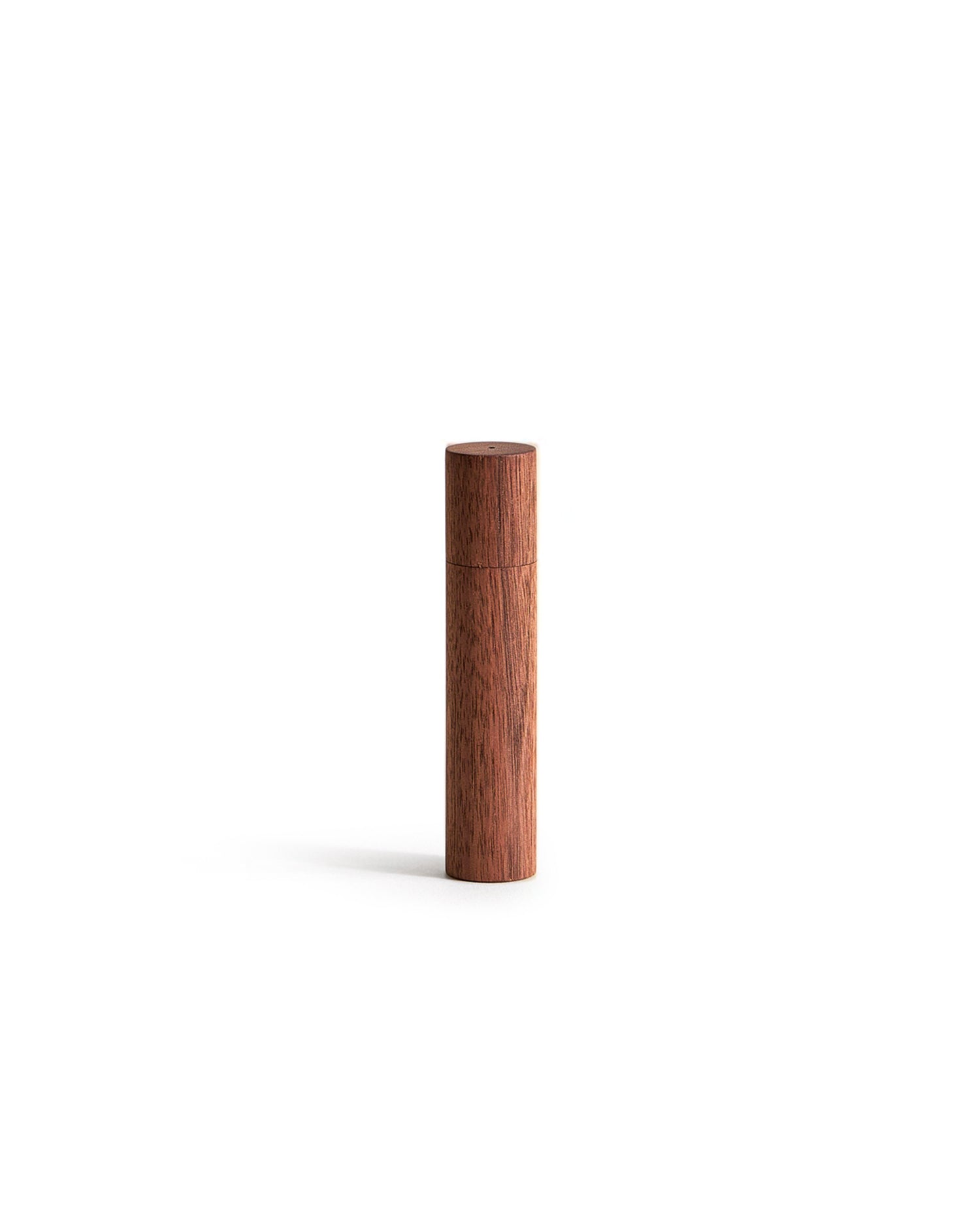 Wooden cylindrical incense case on a white background