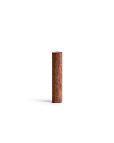 Wooden cylindrical incense case on a white background