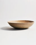 Side view of Large White Urushi Walnut Carved Bowl by Ryuji Mitani against white-gray background.
