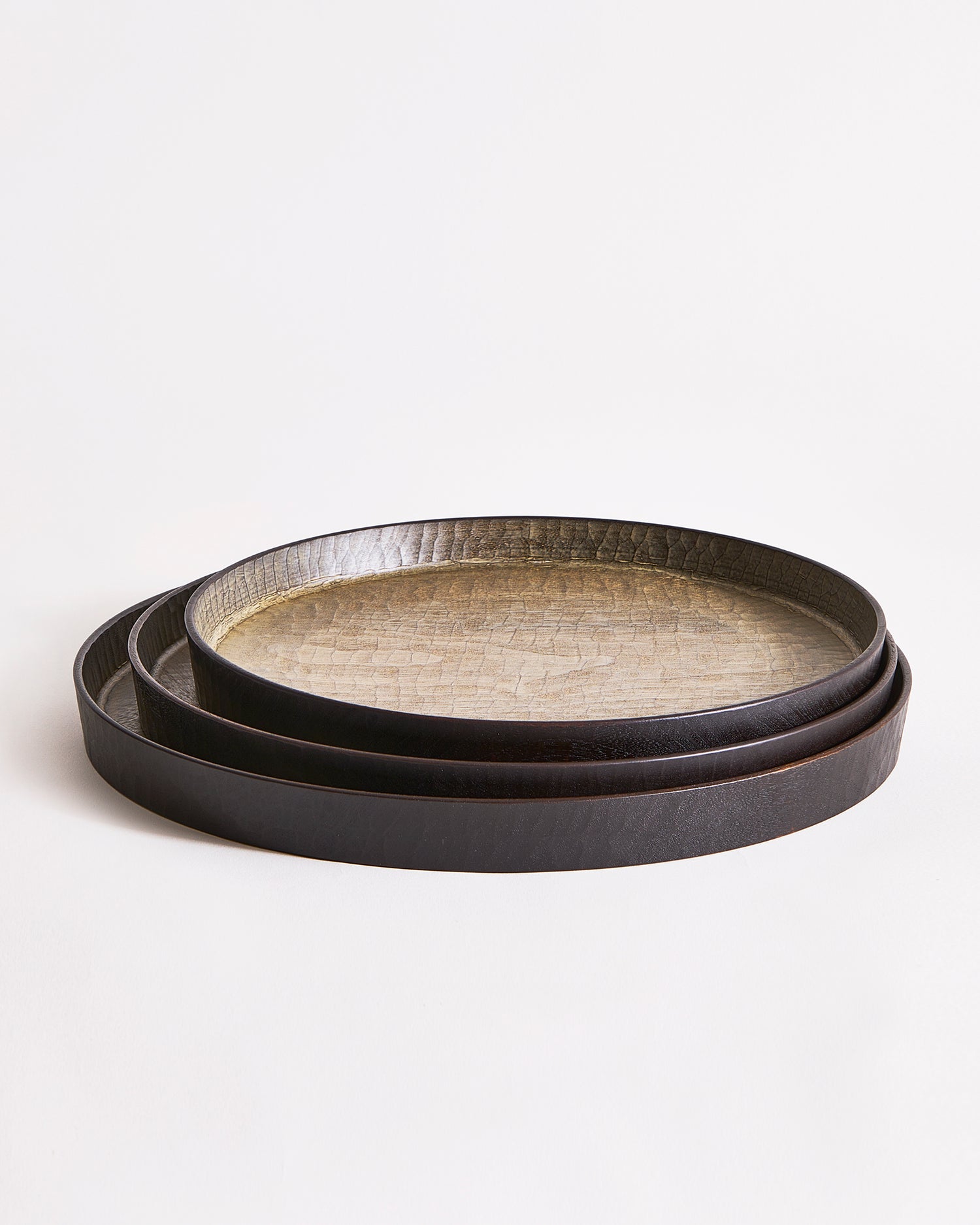 Stacked trays with textured surface by Ryuji Mitani on a light gray background