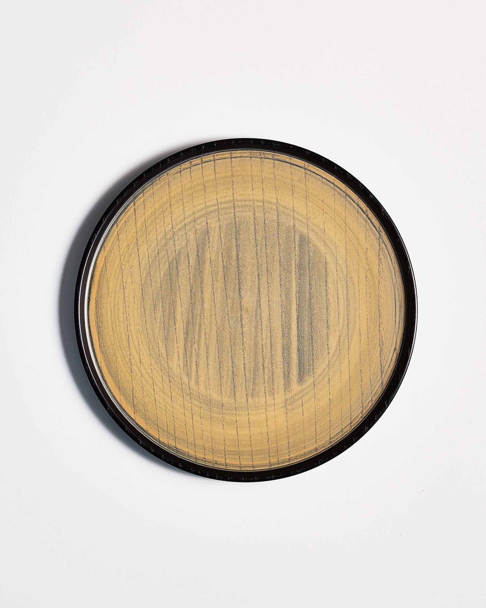 Top view of Usuzumi Round Oak Tray by Ryuji Mitani against white-gray background. Variation of brushstroke. 