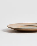 Cropped view of small White Urushi Plate by Ryuji Mitani against white-gray background. 