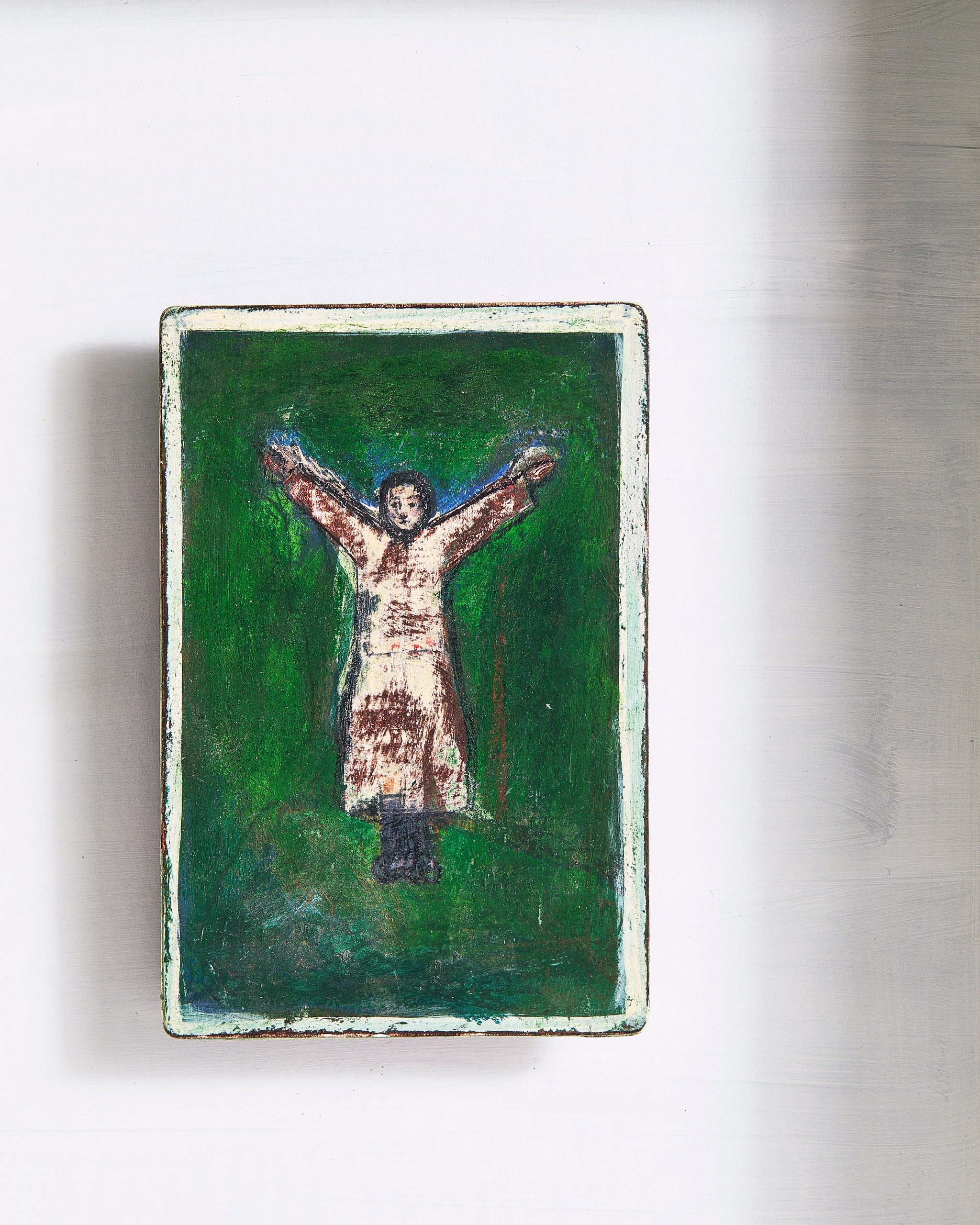 Small gouche painting of a figure standing in a Y-shape with a green background