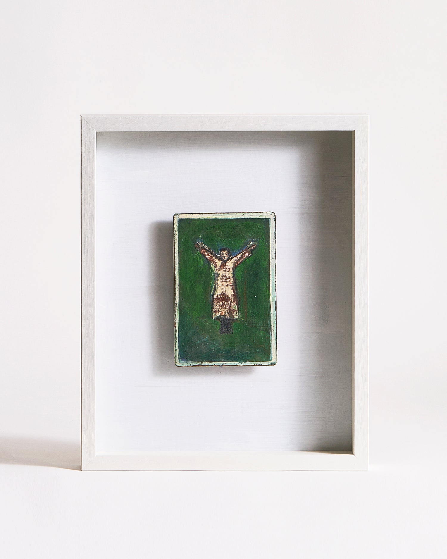 Framed artwork of a person standing in a Y-shape on a green background