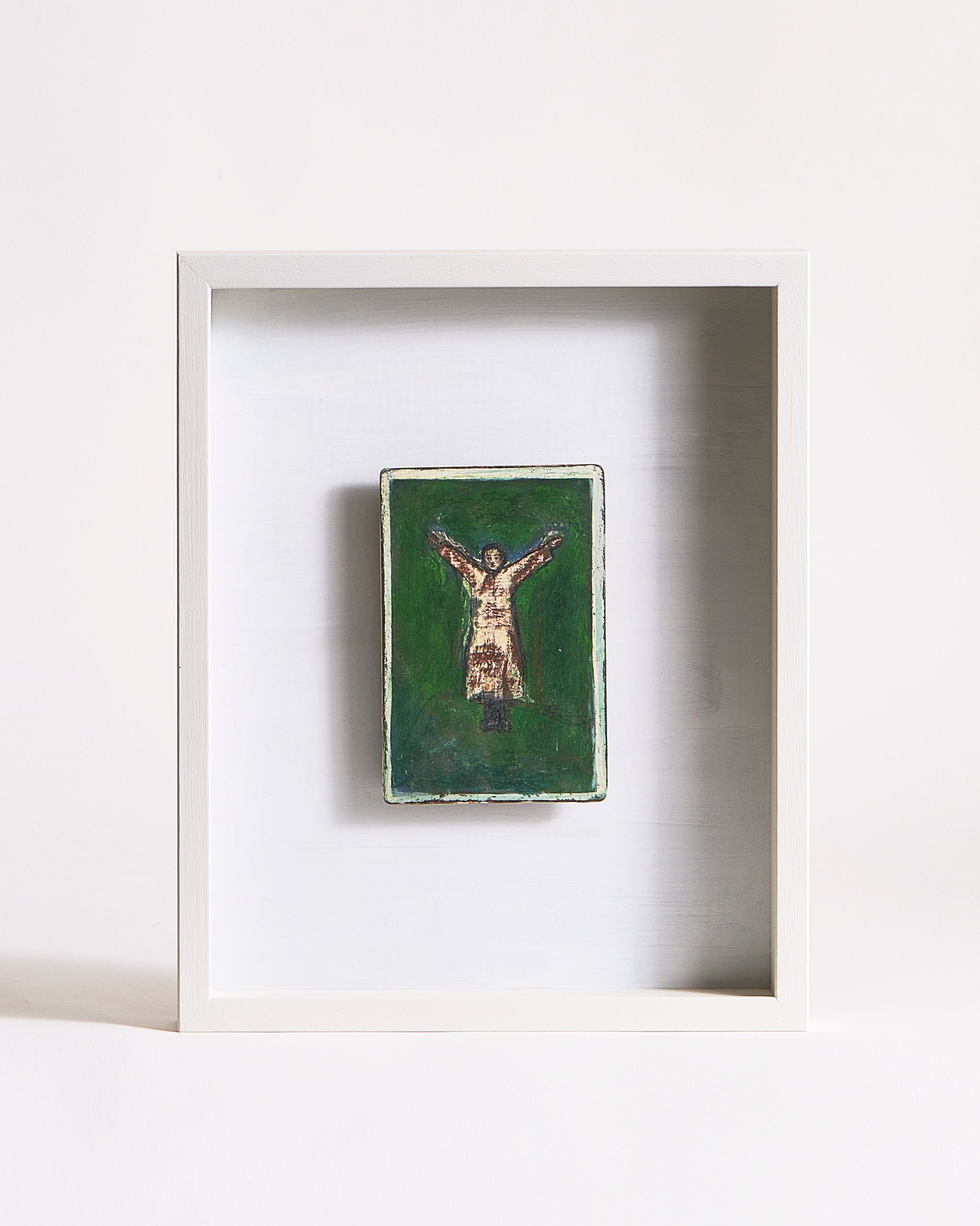 Framed artwork of a person standing in a Y-shape on a green background