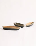 Three boat bowls with beige and black exteriors on a gray background