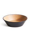 Wooden bowl with black exterior and beige interior on a white background
