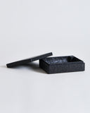 Black rectangular, wooden box with lid by Ryuji Mitani on a light gray background