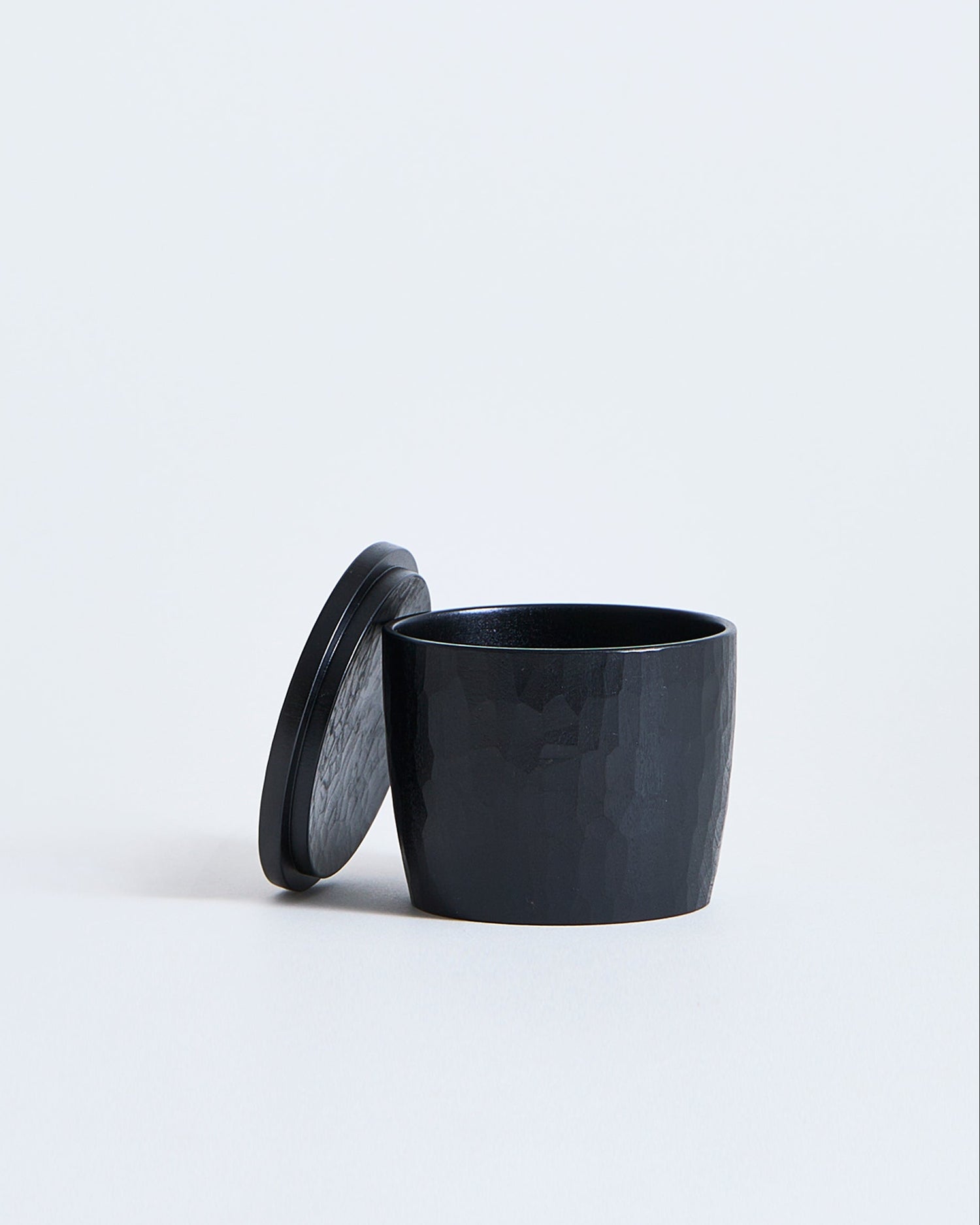 Black wooden cup with lid by Ryuji Mitani on a white background