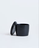 Black wooden cup with lid by Ryuji Mitani on a white background