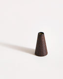 Deep brown wooden cone-shaped incense holder on a gray background