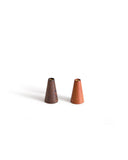 Two small wooden cone-shaped incense holders on a white background