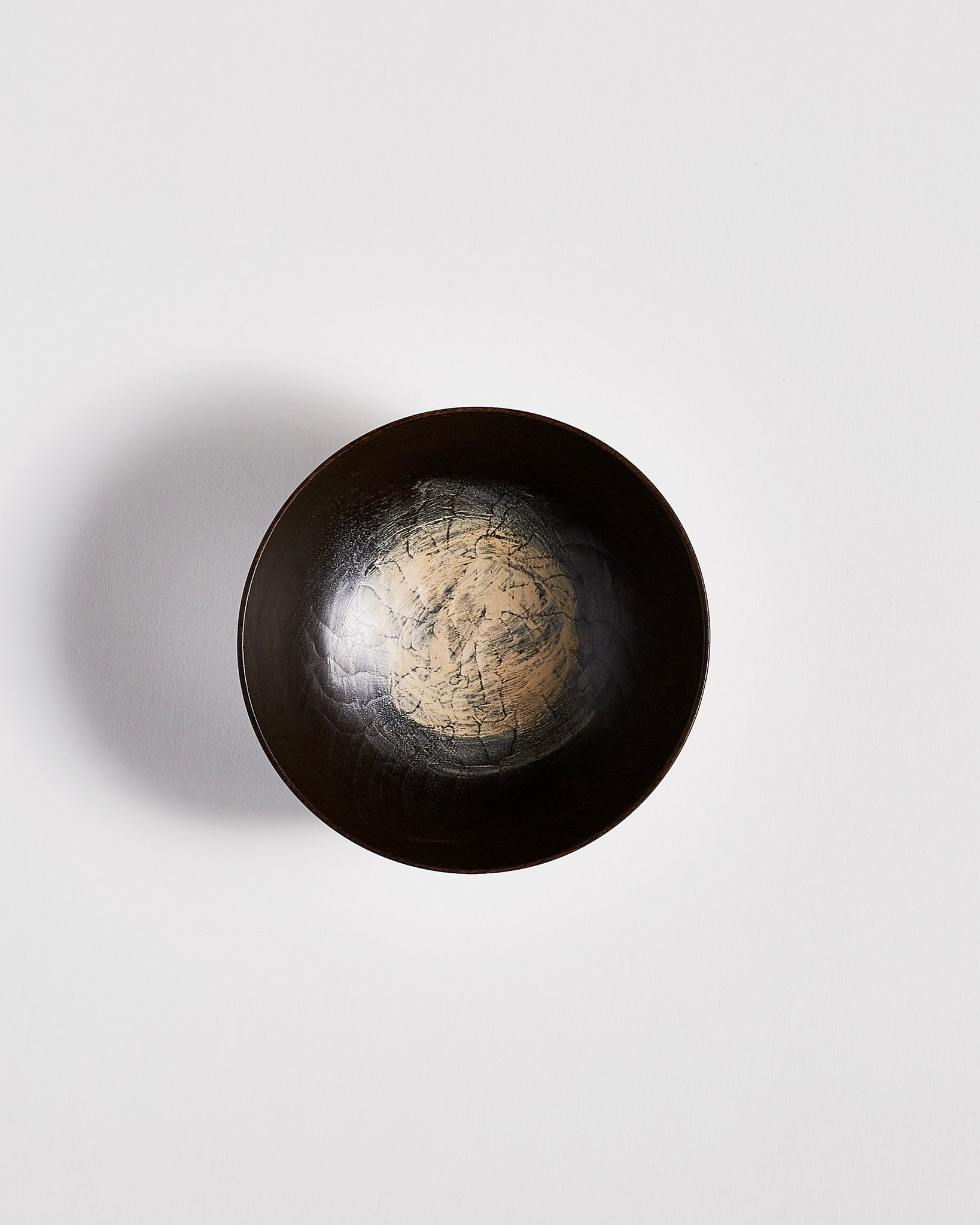 Top view of Usuzumi Black Walnut Bowl by Ryuji Mitani against white-gray background. Variation of brushstroke. 