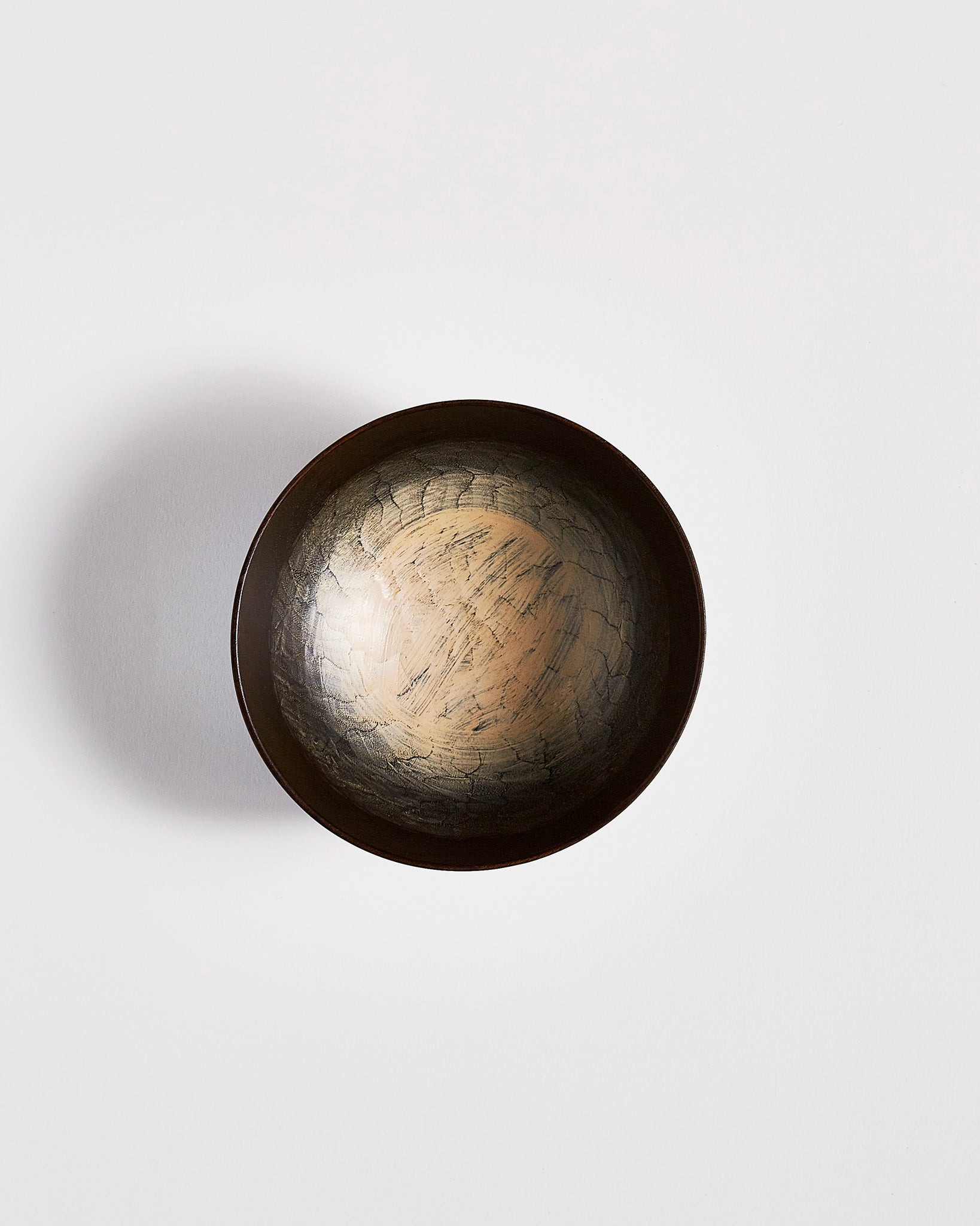 Top view of Usuzumi Black Walnut Bowl by Ryuji Mitani against white-gray background. Variation of brushstroke. 