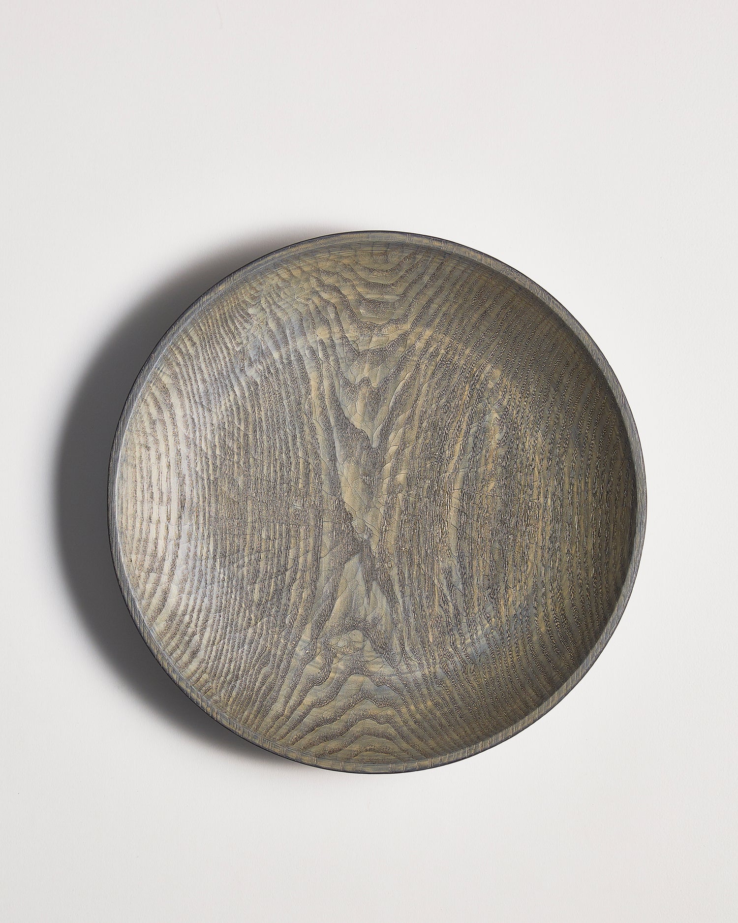 Round wooden bowl by Ryuji mitani on a light gray background