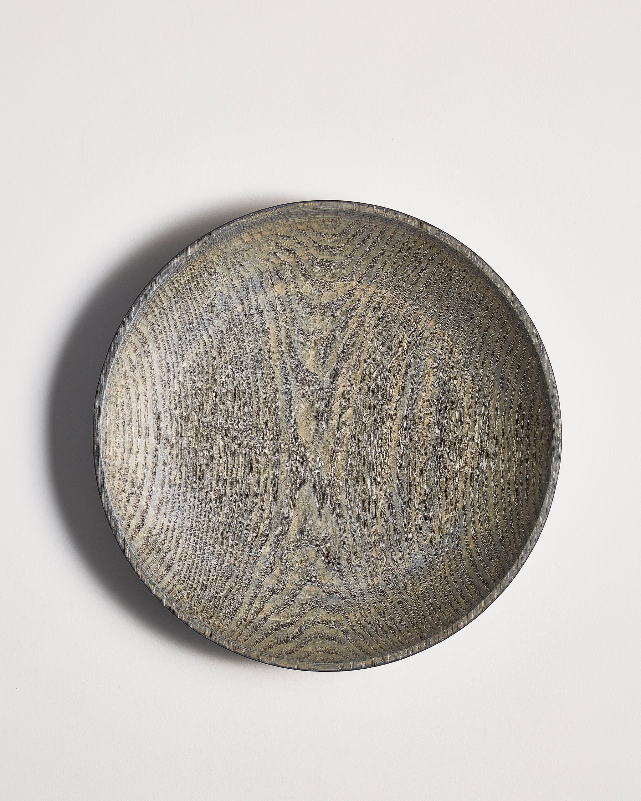 Round wooden bowl by Ryuji mitani on a light gray background